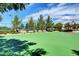 A full outdoor basketball court is surrounded by benches, beautiful mature trees, and well-maintained landscaping at 3717 Rocklin Peak Ave, North Las Vegas, NV 89081