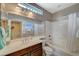 Bright bathroom featuring a white countertop, shower-tub combo with a glass shower door, and a tiled floor at 3717 Rocklin Peak Ave, North Las Vegas, NV 89081