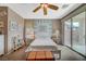 Light-filled bedroom with a ceiling fan and a sliding glass door leading to the backyard at 3717 Rocklin Peak Ave, North Las Vegas, NV 89081