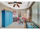 Cozy bedroom featuring a ceiling fan, a colorful desk, and a vibrant blue wardrobe at 3717 Rocklin Peak Ave, North Las Vegas, NV 89081