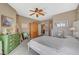 Charming bedroom featuring a ceiling fan and view into another room, as well as a decorative dresser at 3717 Rocklin Peak Ave, North Las Vegas, NV 89081