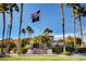 Community clubhouse framed by palm trees, featuring a flag pole with the American flag at 3717 Rocklin Peak Ave, North Las Vegas, NV 89081