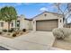 Home featuring desert landscaping, a two-car garage and beige stucco siding at 3717 Rocklin Peak Ave, North Las Vegas, NV 89081