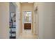 Hallway view of a bathroom with a vanity, dual sinks, and tile flooring at 3717 Rocklin Peak Ave, North Las Vegas, NV 89081