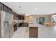 Kitchen featuring stainless steel appliances, dark cabinetry, and an island with granite countertops at 3717 Rocklin Peak Ave, North Las Vegas, NV 89081