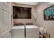 A laundry room with a side-by-side washer and dryer and overhead storage at 3717 Rocklin Peak Ave, North Las Vegas, NV 89081