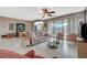 Comfortable living room with tile floors, wicker furniture, and sliding glass doors to the patio at 3717 Rocklin Peak Ave, North Las Vegas, NV 89081