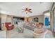 Open-concept living room with kitchen and dining areas in a neutral palette at 3717 Rocklin Peak Ave, North Las Vegas, NV 89081