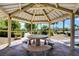 Covered picnic area with a round table and benches offers a shady spot for outdoor dining at 3717 Rocklin Peak Ave, North Las Vegas, NV 89081