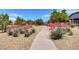 Stroll along the community walking path amidst colorful landscaping and mature trees at 3717 Rocklin Peak Ave, North Las Vegas, NV 89081