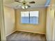 Carpeted bedroom featuring a ceiling fan with lights and a view of the backyard at 3729 La Junta Dr, Las Vegas, NV 89120