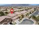 Aerial view of neighborhood with a tan house with a red pin marking it at 4036 W Bird Man Ln, North Las Vegas, NV 89084