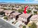 View of a two story house from above, with tiled roof, landscaping and a two car garage at 4036 W Bird Man Ln, North Las Vegas, NV 89084