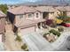 Aerial shot showcases a two-story house with a tile roof and desert landscaping at 4036 W Bird Man Ln, North Las Vegas, NV 89084