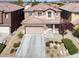 A beautiful two-story house with a red tile roof, desert landscaping, and attached garage at 4036 W Bird Man Ln, North Las Vegas, NV 89084