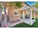 Backyard with a covered patio, grill, sliding glass door, and red brick trim accents at 4036 W Bird Man Ln, North Las Vegas, NV 89084