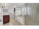 Bathroom with double vanity, glass shelving, shower and bathtub at 4036 W Bird Man Ln, North Las Vegas, NV 89084