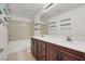 Bathroom featuring double vanity with dark cabinets, enhancing space and reflecting light in the room at 4036 W Bird Man Ln, North Las Vegas, NV 89084