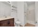 Modern bathroom featuring a vanity, toilet, shower and glass shelving at 4036 W Bird Man Ln, North Las Vegas, NV 89084