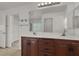 Bathroom featuring double vanity, mirror and shelving at 4036 W Bird Man Ln, North Las Vegas, NV 89084