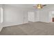 Spacious bedroom with carpet, ceiling fan and views to bathroom at 4036 W Bird Man Ln, North Las Vegas, NV 89084