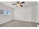 Bright bedroom with carpeted floors, ceiling fan, and window with blinds at 4036 W Bird Man Ln, North Las Vegas, NV 89084
