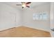 Bright neutral bedroom with ceiling fan, double doors, and modern flooring at 4036 W Bird Man Ln, North Las Vegas, NV 89084