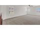 Bonus room with neutral carpet, three windows, and a ceiling fan at 4036 W Bird Man Ln, North Las Vegas, NV 89084