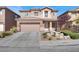 Charming two-story home with a landscaped front yard and a two car garage at 4036 W Bird Man Ln, North Las Vegas, NV 89084