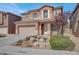 Charming two-story home with a well-manicured lawn, front porch, and attached two-car garage at 4036 W Bird Man Ln, North Las Vegas, NV 89084