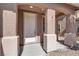 Inviting front entrance with textured columns, covered porch, and a white front door at 4036 W Bird Man Ln, North Las Vegas, NV 89084