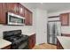 Modern kitchen with stainless steel microwave and gas cooktop plus white countertops at 4036 W Bird Man Ln, North Las Vegas, NV 89084