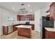 Bright open kitchen featuring stainless appliances, dark cabinetry, and modern countertops at 4036 W Bird Man Ln, North Las Vegas, NV 89084