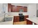 Bright kitchen with stainless steel appliances, dark cabinetry, and bright countertops at 4036 W Bird Man Ln, North Las Vegas, NV 89084