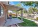 Cozy covered patio featuring a grill, concrete flooring, and a view of the fenced backyard at 4036 W Bird Man Ln, North Las Vegas, NV 89084