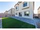 Backyard featuring a patio area and artificial turf at 480 Silverweed Ave, Henderson, NV 89044