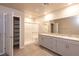 Bright bathroom with double sinks, granite counters, walk-in shower and linen closet at 480 Silverweed Ave, Henderson, NV 89044