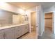 Modern bathroom featuring double sinks, granite countertops and tiled floors at 480 Silverweed Ave, Henderson, NV 89044