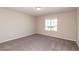 Simple carpeted bedroom with window and neutral paint at 480 Silverweed Ave, Henderson, NV 89044