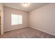 A serene bedroom with a large window, neutral walls and plush carpeting, creating a peaceful sanctuary at 480 Silverweed Ave, Henderson, NV 89044