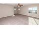 Spacious bedroom with ceiling fan, carpet flooring, and natural light at 480 Silverweed Ave, Henderson, NV 89044
