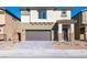 Lovely two-story home boasts a two-car garage, desert landscaping, and a welcoming front entrance at 480 Silverweed Ave, Henderson, NV 89044