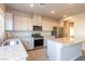 Modern kitchen with stainless steel appliances, granite countertops, a kitchen island, and ample storage at 480 Silverweed Ave, Henderson, NV 89044