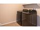 Modern laundry room with new black Samsung washer and dryer appliances at 480 Silverweed Ave, Henderson, NV 89044