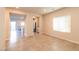Bright and open living room with tile floors that lead to the kitchen creating an inviting space for relaxation at 480 Silverweed Ave, Henderson, NV 89044