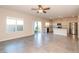 Bright living room features tile floors, a ceiling fan, and access to the backyard, seamlessly connecting indoor and outdoor living at 480 Silverweed Ave, Henderson, NV 89044