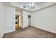 Bright bedroom featuring carpet, white walls, ceiling fan and in-unit stacked washer and dryer at 51 E Agate Ave # 506, Las Vegas, NV 89123