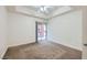Bedroom with carpet flooring, a ceiling fan, and a sliding glass door to the balcony at 51 E Agate Ave # 506, Las Vegas, NV 89123