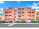 Exterior building view with manicured bushes and colorful paint scheme at 51 E Agate Ave # 506, Las Vegas, NV 89123