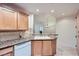 Kitchen featuring granite counters, wood cabinets, stainless steel appliances, and a dining area at 51 E Agate Ave # 506, Las Vegas, NV 89123